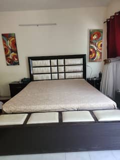 king size bed with storage and bed side tables