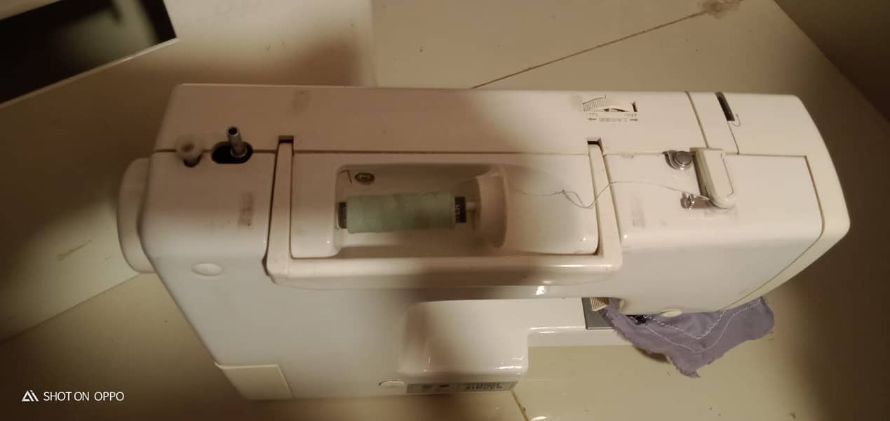 A unique style Japanese brand sewing machine. 13