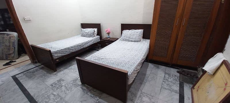 Single beds with spring mattresses and side table. 9