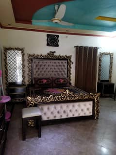 king size bed with side tables attached mirrors and one dressing table