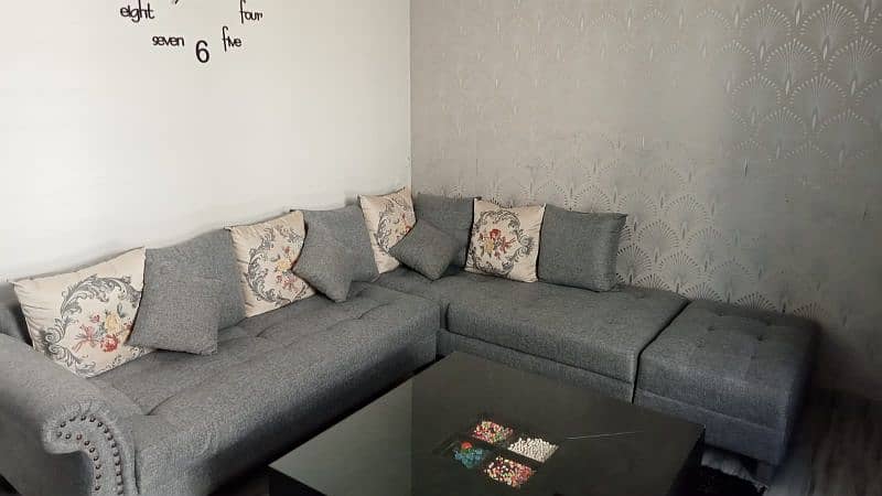 7 seater L shaped Sofa in Charcoal grey colour me 1