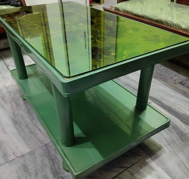 Plastic table with glass top for sale. 2