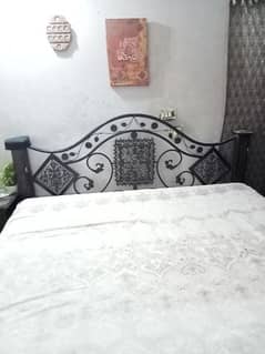 full size iron bed with two side tables without mattress