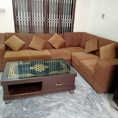 L shaped sofa with cushions and table