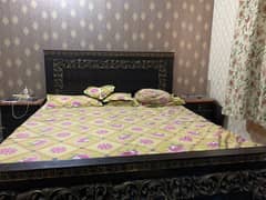Wooden bed with dressing table and mirror