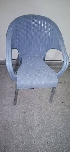 2x plastic chairs alongwith a central table. 0