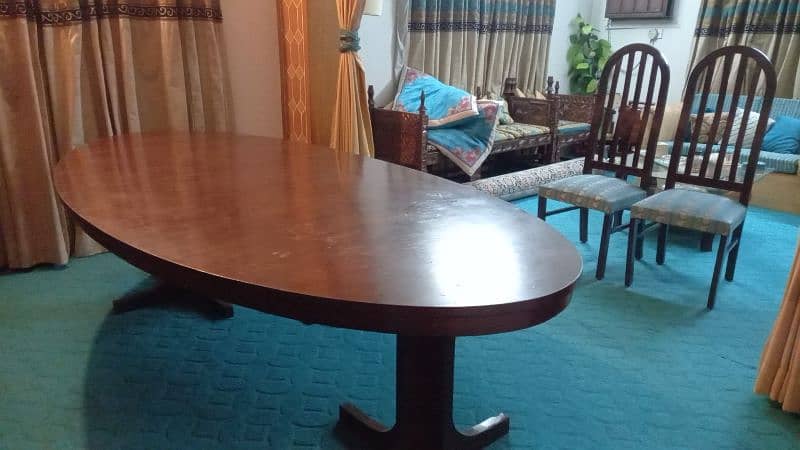 Eight seater,  wooden, oval shaped dinning table for sale 4