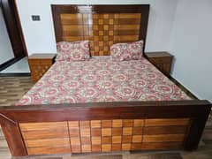 wooden bed with mattress and matching dressing table and mirror