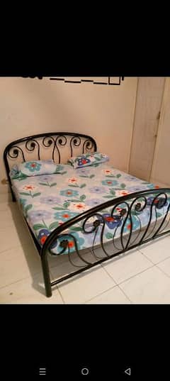 iron bed wooden cupboard