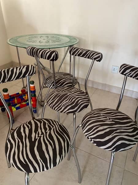 modern dinning ; iron stand with glass table and four chairs for sale 2