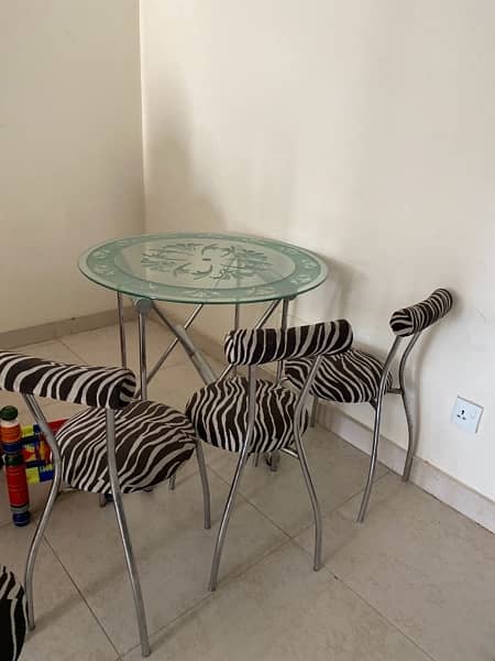 modern dinning ; iron stand with glass table and four chairs for sale 3