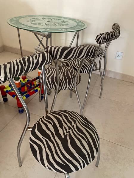 modern dinning ; iron stand with glass table and four chairs for sale 4