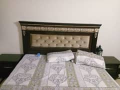 wooden double bed and dressing table