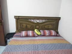 Bed with mattress and cupboard