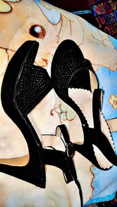 black heels with black small stones likely new