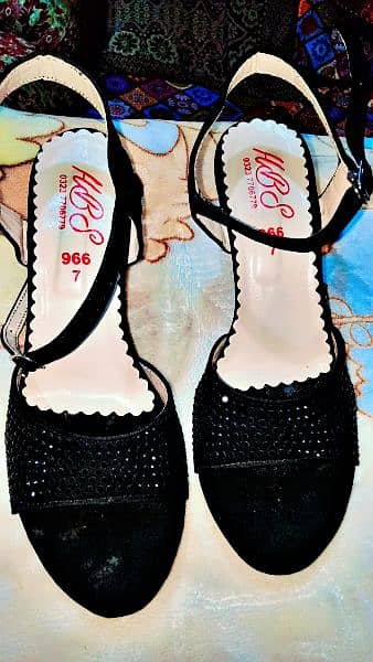 black heels with black small stones likely new 1