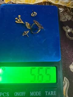 one gold ring one pair earing and a locket for sale