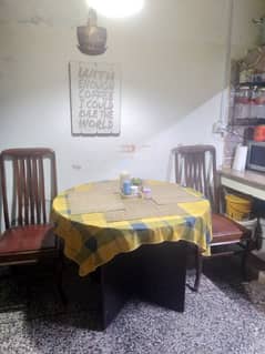 four men round dining table in immaculate condition.