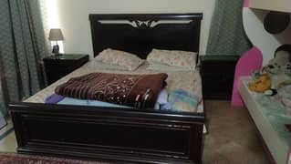Queen Sized Double Bed with 2 side tables and a dressing table.
