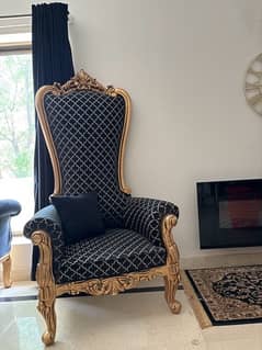 pair of black and gold high back chairs 0
