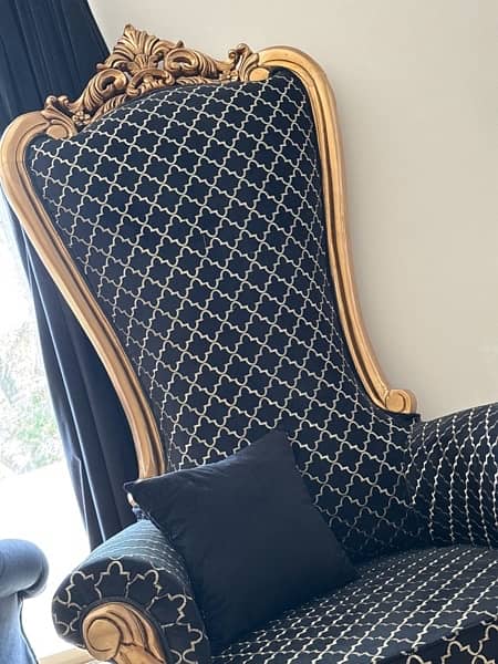 pair of black and gold high back chairs 1