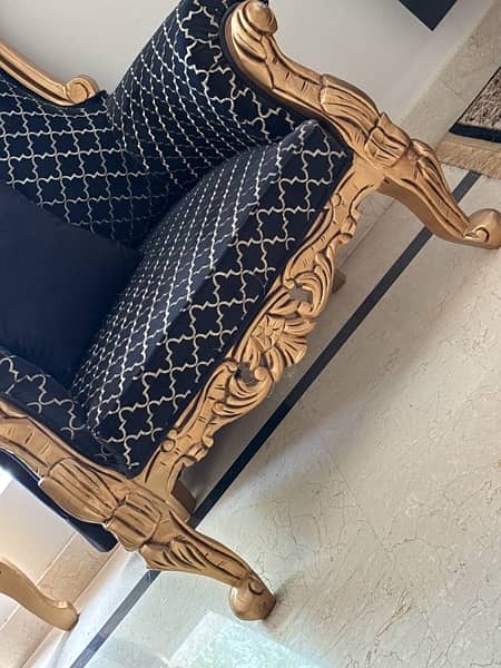 pair of black and gold high back chairs 2