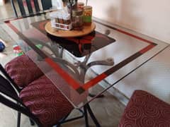 dinning table. 4 chairs and glass table. one chair set is broken. 0