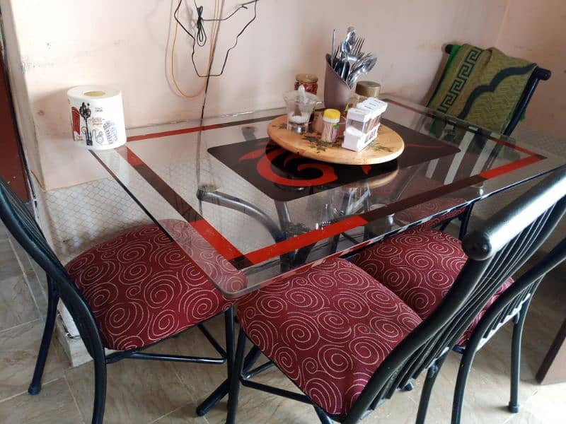 dinning table. 4 chairs and glass table. one chair set is broken. 2