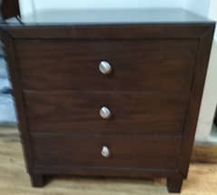 two single beds with side table and dressing table