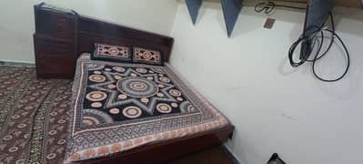 Wooden bed with mattress and side drwal