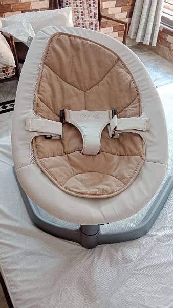 Nuna rocking baby chair for newborns, moving, and still lock options. 1