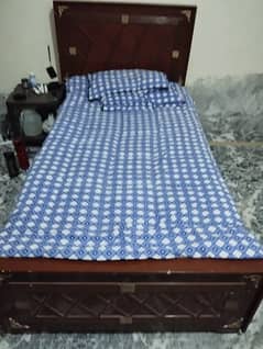 Wooden single bed with mattress