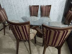 wooden chair and glass dining table with wood base