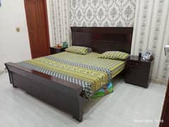 wooden bed with 2 side tables and mattress