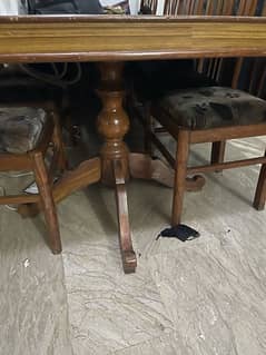 large solid wood table with 6 chairs. .
