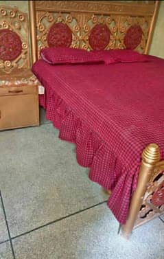 iron bed with one side table