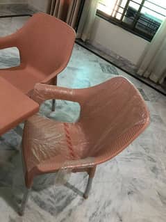 Lightly used plastic chairs and table 0