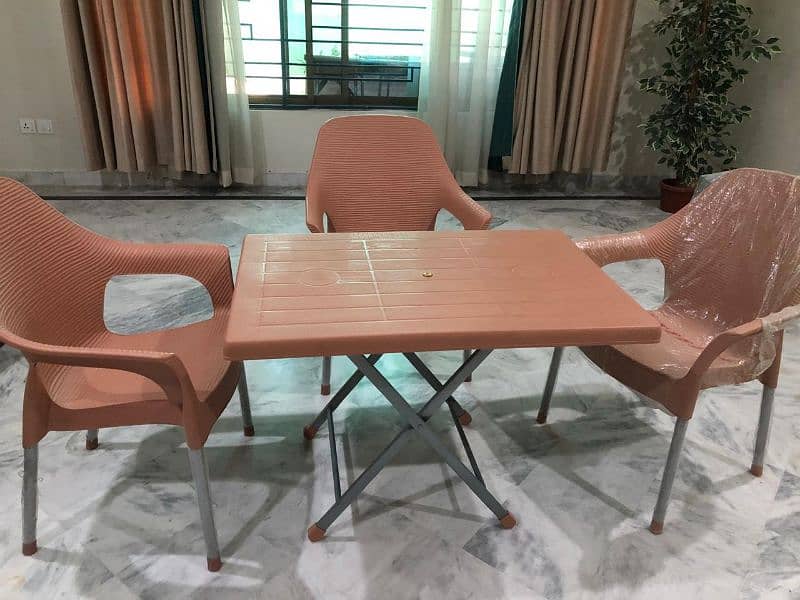 Lightly used plastic chairs and table 1