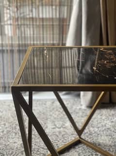 black and golden square shape coffee table