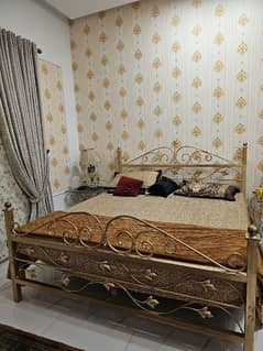 Rot Iron bed with sidetables and mattress.