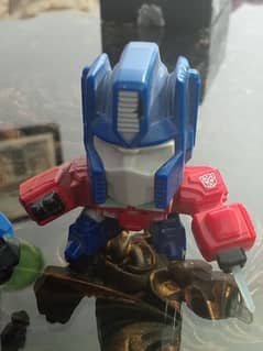 Preloved Transformers Optimus Prime figurines.