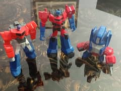 Preloved Transformers Optimus Prime figurines.