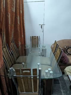 Glass dining table with six chairs