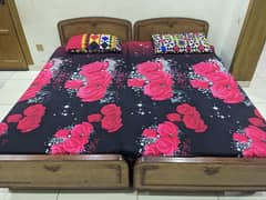 2 single wooden beds