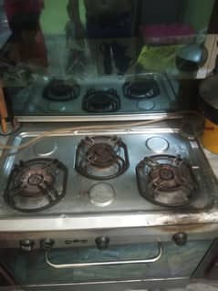 Care" company gas cooking range. good condition