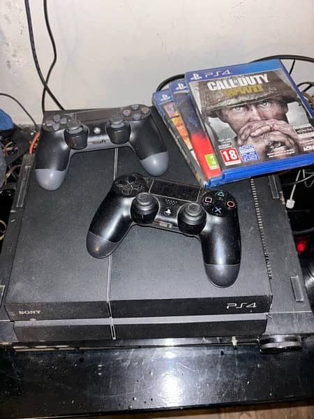 PlayStation 4 fat for sale with 2 gaming controllers 1