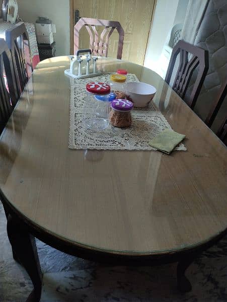 dinning table with 6 chairs a glass on the table 3