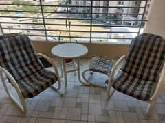 outdoor chairs and table with a stool