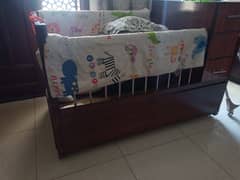 Solid wood baby cot with storage for urgent sale 0