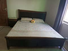 Wooden bed with 2 side tables and a mattress
